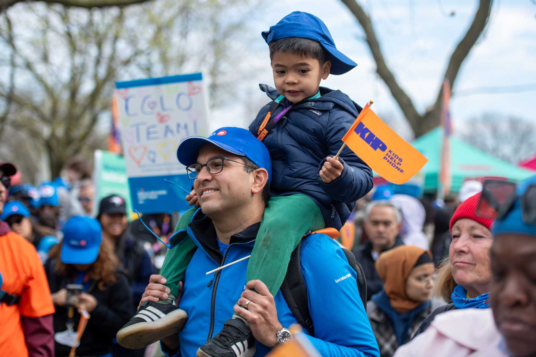 A young boy on his father's shoulder at the event